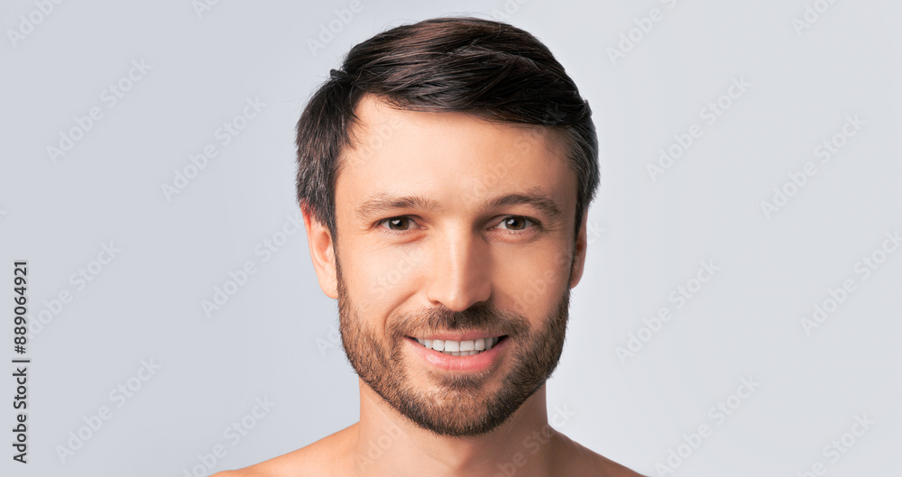 Fototapeta premium Portrait Of Smiling Middle Aged Man Looking At Camera Over White Background. Studio Shot, Panorama