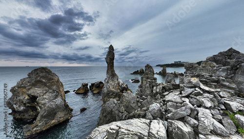 High angle and panoramic view of Candlestick Rock against sea horizon and dark cloud in the sky at Chuam near Donghae-si, South Korea
 photo