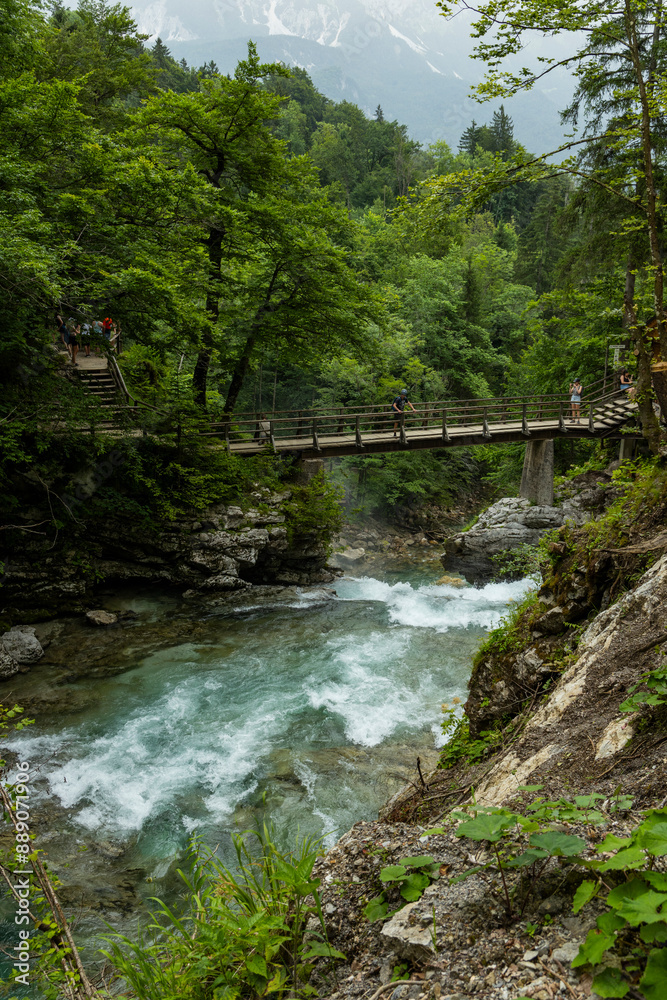 Vintgar Gorges Park a few km from Lake Bled, Slovenia. Wooden walkways accompany the path above the river rapids and waterfalls. River hits rocks and creates fog.Adventure family holidays. Freshness. Vintgar Gorges Park a few km from Lake Bled, Slovenia. Wooden walkways accompany the path above the river rapids and waterfalls. River hits rocks and creates fog.Adventure family holidays. Freshness.