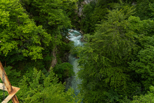 Vintgar Gorges Park a few km from Lake Bled, Slovenia. Wooden walkways accompany the path above the river rapids and waterfalls. River hits rocks and creates fog.Adventure family holidays. Freshness.