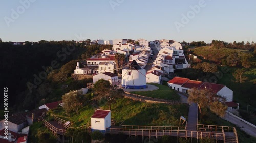Aerial view of charming windmill village with rustic houses and quaint rooftops, Odeceixe, Portugal.