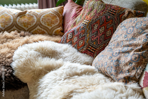 A cozy corner with a selection of decorative pillows and cushions showcasing various textures and patterns on a sofa. photo