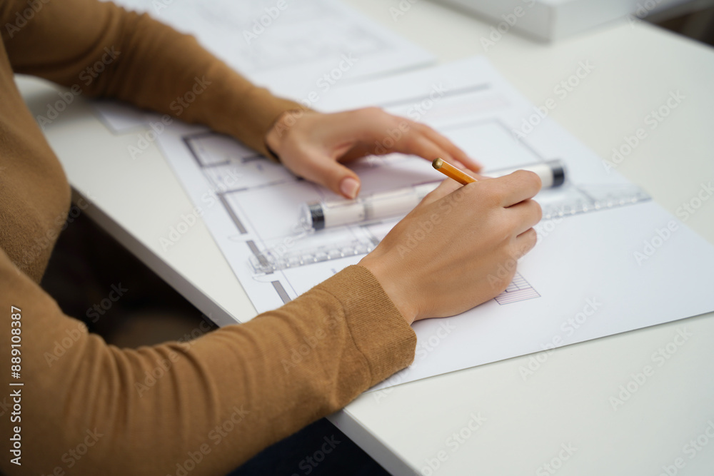Unrecognizable woman architect working with blueprints in office Unrecognizable woman architect working with blueprints in office