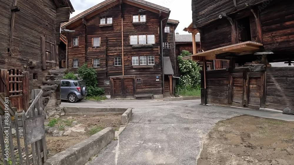 Traditional Wooden Swiss Chalets In Historical Mountain Village of Reckingen In Goms, Valais, Switzerland. dolly-in shot Traditional Wooden Swiss Chalets In Historical Mountain Village of Reckingen In Goms, Valais, Switzerland. dolly-in shot