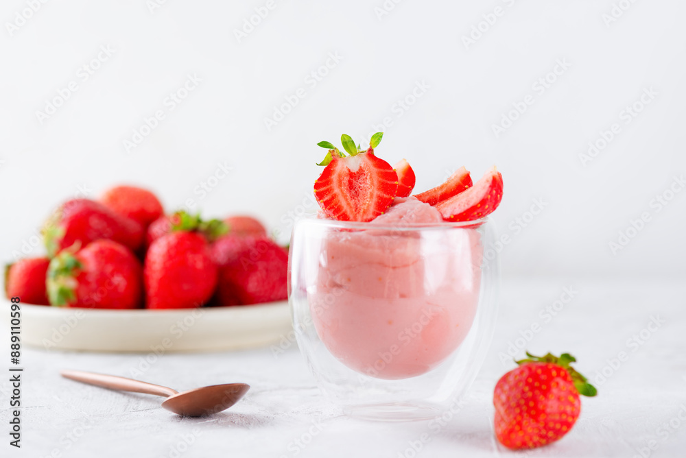 Tofu and strawberry mousse dessert in a glass on a white table. Vegan food. Lactose and sugar free. Tofu and strawberry mousse dessert in a glass on a white table. Vegan food. Lactose and sugar free.