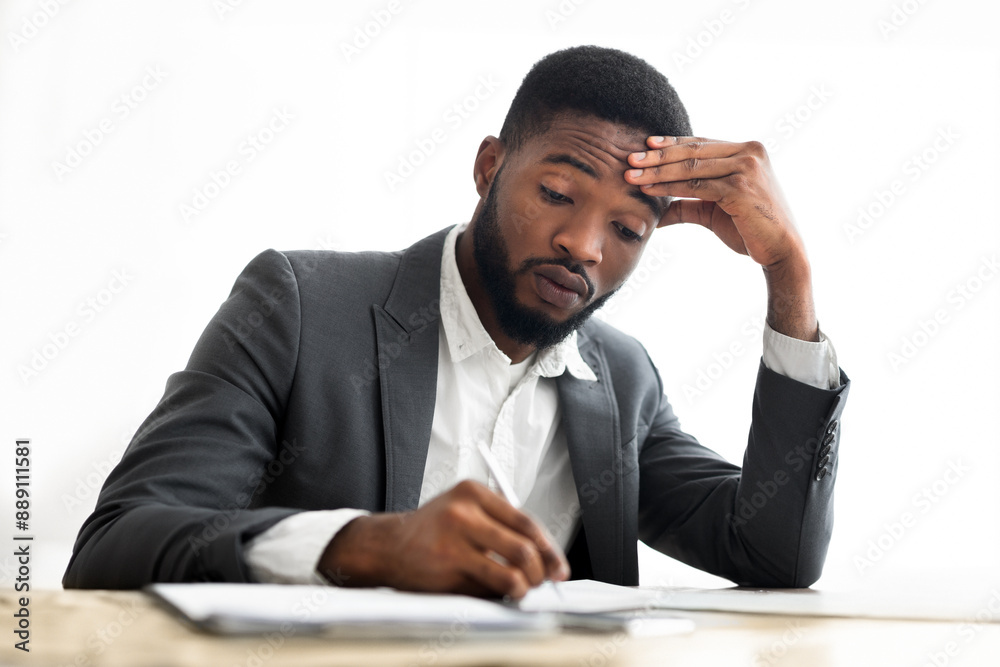 Busy businessman in formal suit signing contracts or agreements at workplace in modern office, copy space Busy businessman in formal suit signing contracts or agreements at workplace in modern office, copy space