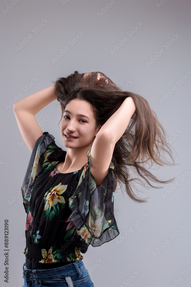 Beautiful young woman playing with her long hair Beautiful young woman playing with her long hair