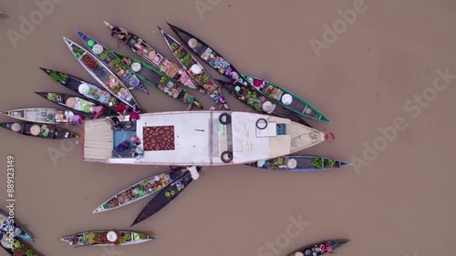 Aerial view of bustling floating market with boats, people, and fruit at Lok Baintan, Banjarmasin, South Kalimantan, Indonesia. photo