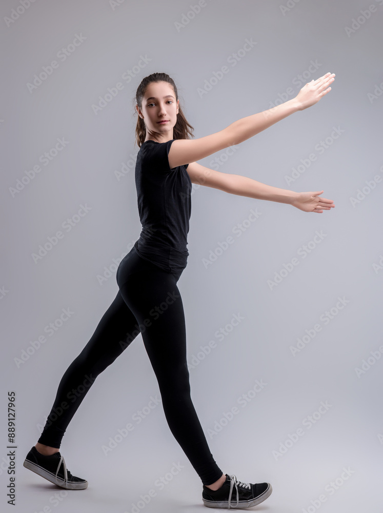 Obraz premium Young woman wearing black practicing dance poses