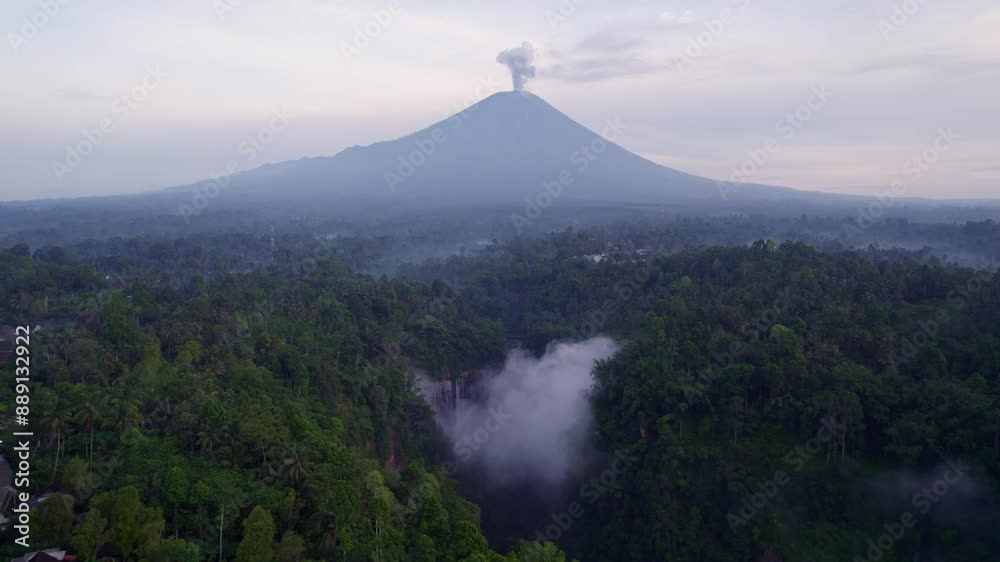 Aerial view of majestic waterfall and volcano in lush forest, Tumpak Sewu, East Java, Indonesia. Aerial view of majestic waterfall and volcano in lush forest, Tumpak Sewu, East Java, Indonesia.