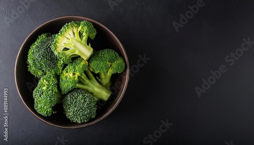  Broccoli in a bowl on a black background, top view, copy space