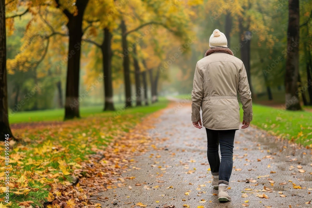 Fototapeta premium A person enjoying a leisurely walk in the park