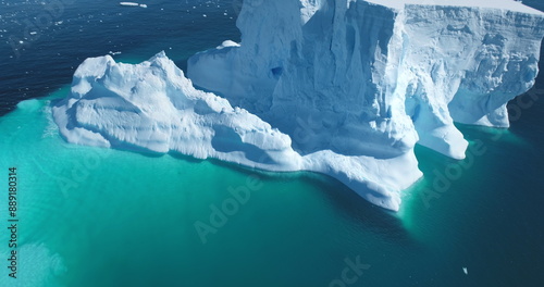 Фотография Close up aerial iceberg calving blue ocean water
