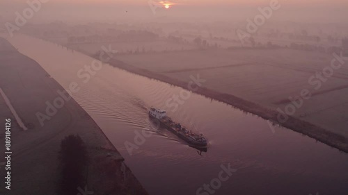 Aerial view of serene sunrise over river and fog in countryside, Jistrum, Netherlands. photo