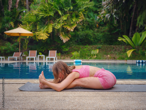 Beautiful woman practices yoga in Crabi, Thailand photo