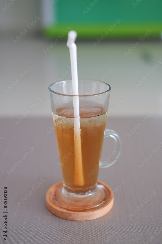 Ice tea in glass on table. Selective focus and shallow depth of field. Ice tea in glass on table. Selective focus and shallow depth of field.