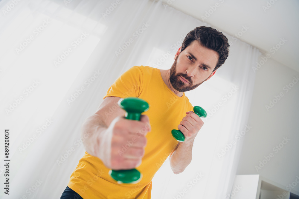 Photo of athletic strong bearded man practicing physical exercises gym indoors house home Photo of athletic strong bearded man practicing physical exercises gym indoors house home
