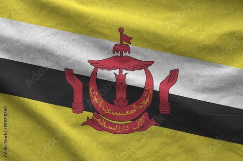 Brunei Darussalam flag depicted on folded wavy fabric of old cloth close up photo