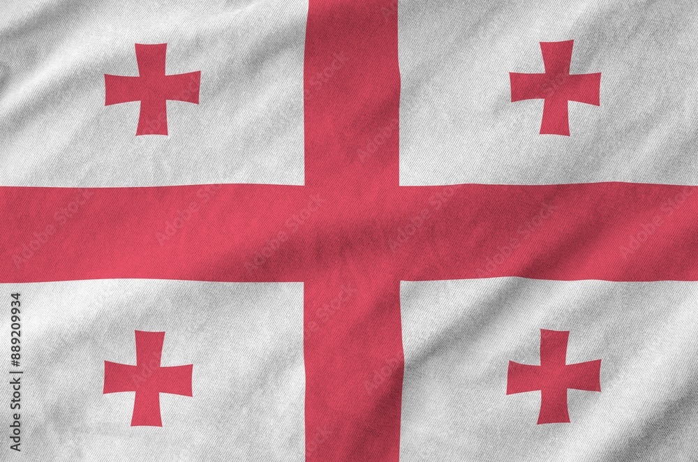 Georgia flag depicted on folded wavy fabric of old cloth close up Georgia flag depicted on folded wavy fabric of old cloth close up