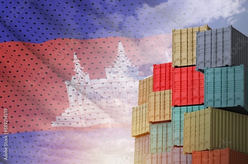 Cambodia flag and big stack of shipping cargo containers in docks with sky background close up photo