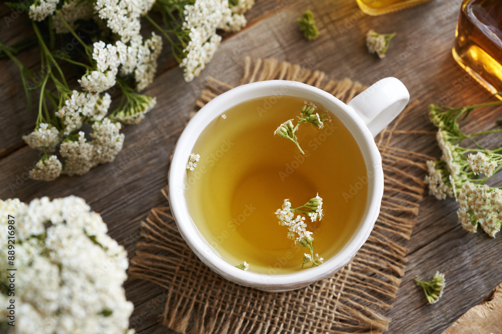 Yarrow tea in a whtie ceramic cup on a table