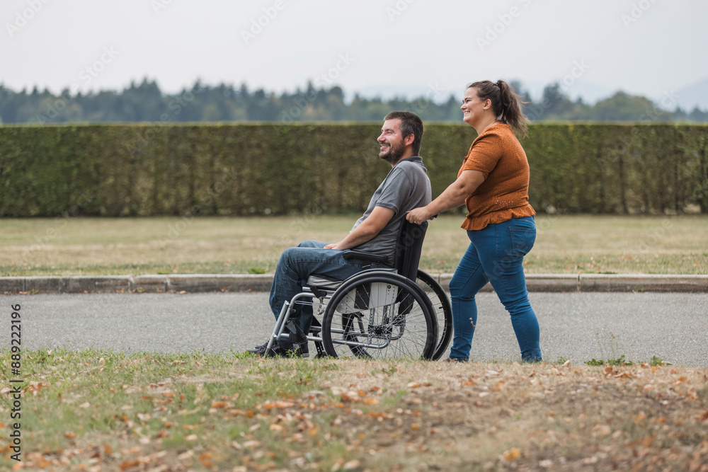 Personal assistant helping a man with disability to push a wheelchair outdoors. Help service concept. Personal assistant helping a man with disability to push a wheelchair outdoors. Help service concept.