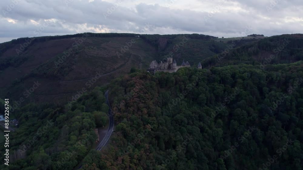 Aerial view of medieval castle surrounded by autumn trees and hills, Bourscheid, Luxembourg. Aerial view of medieval castle surrounded by autumn trees and hills, Bourscheid, Luxembourg.