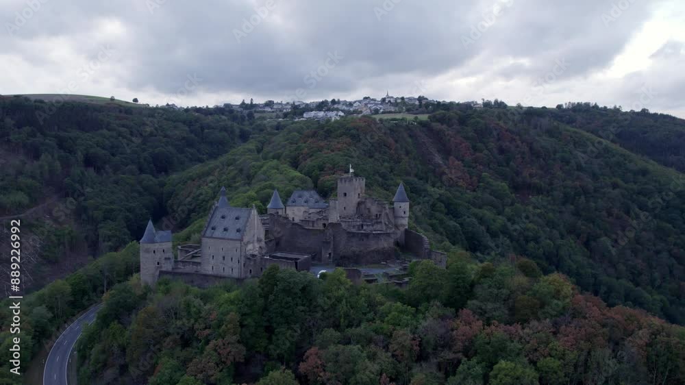 Aerial view of medieval castle surrounded by autumn trees and hills, Bourscheid, Luxembourg. Aerial view of medieval castle surrounded by autumn trees and hills, Bourscheid, Luxembourg.
