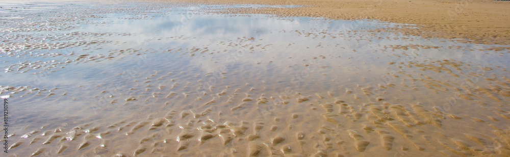 Sand beach along a sea under a blue cloudy sky in bright sunlight in summer, Walcheren, Zeeland, the Netherlands, July, 2024 Sand beach along a sea under a blue cloudy sky in bright sunlight in summer, Walcheren, Zeeland, the Netherlands, July, 2024