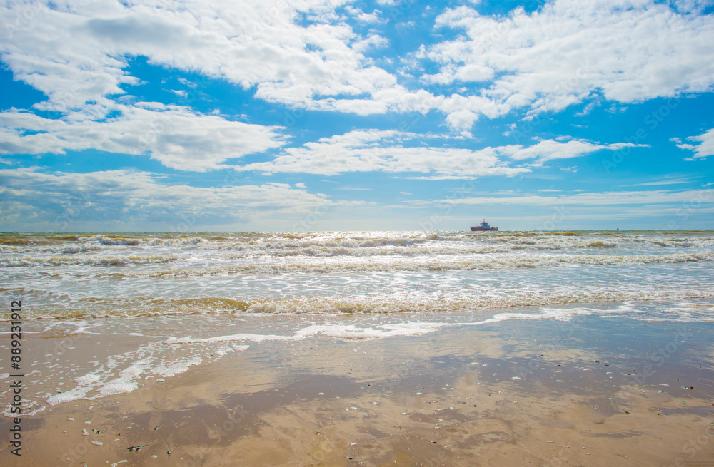 Sand beach along a sea under a blue cloudy sky in bright sunlight in summer, Walcheren, Zeeland, the Netherlands, July, 2024 Sand beach along a sea under a blue cloudy sky in bright sunlight in summer, Walcheren, Zeeland, the Netherlands, July, 2024