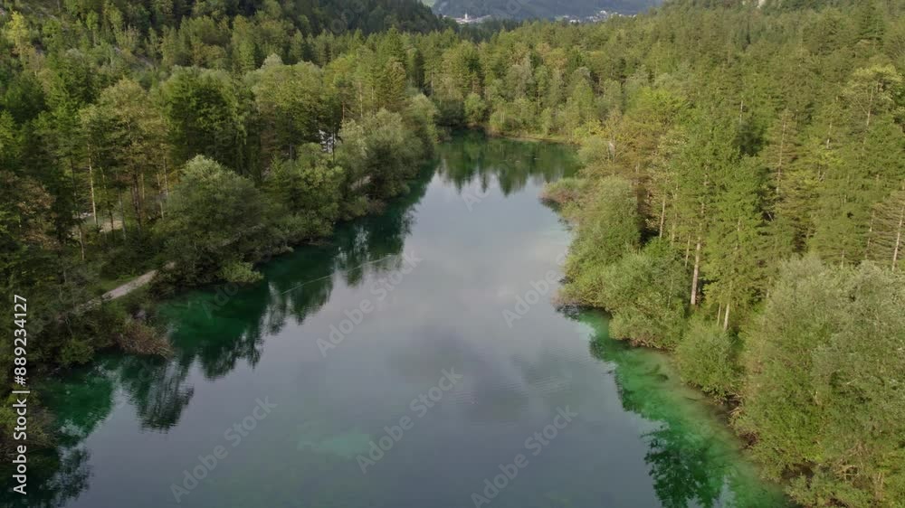 Aerial view of serene Bluntauseen lake surrounded by lush forest and majestic mountains, Golling an der Salzach, Austria. Aerial view of serene Bluntauseen lake surrounded by lush forest and majestic mountains, Golling an der Salzach, Austria.