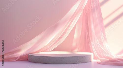 A soft pink fabric drapes over a round podium, bathed in warm sunlight. photo