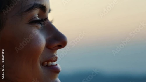 This Content woman smiling and enjoying the view of the horizon. Emotion dreamy look
