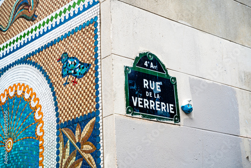 Fototapeta Naklejka Na Ścianę i Meble -  Street sign of Rue de la Verriere with mosaics and street art, a street with restaurants and warm atmosphere in the Marais, 4th arrondissment, Paris, France