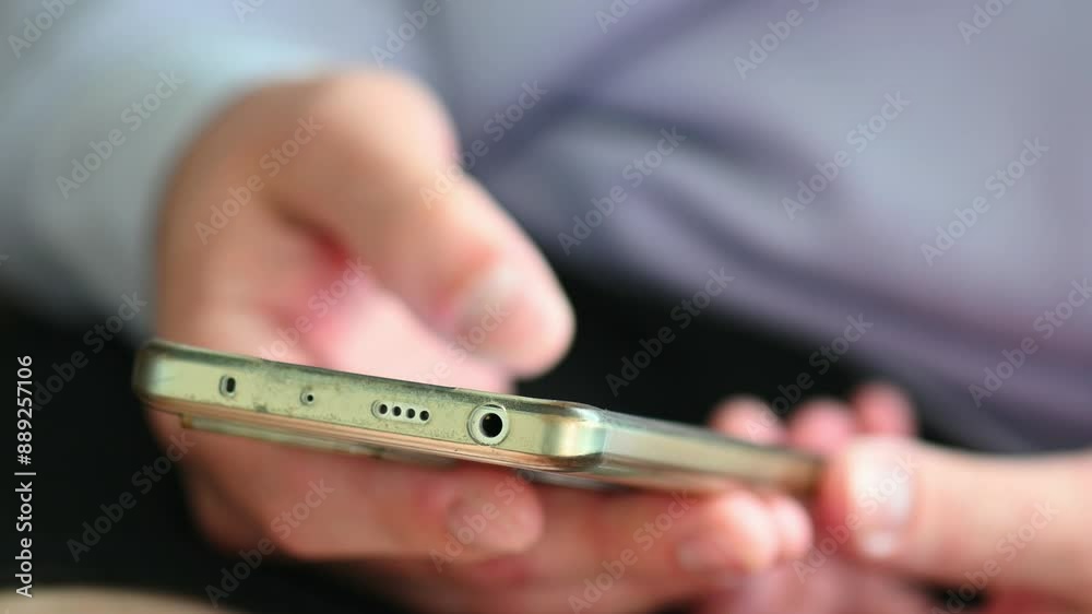 Close-up of person hand scrolling something on his mobile phone, concept video about doomscrolling and waste time