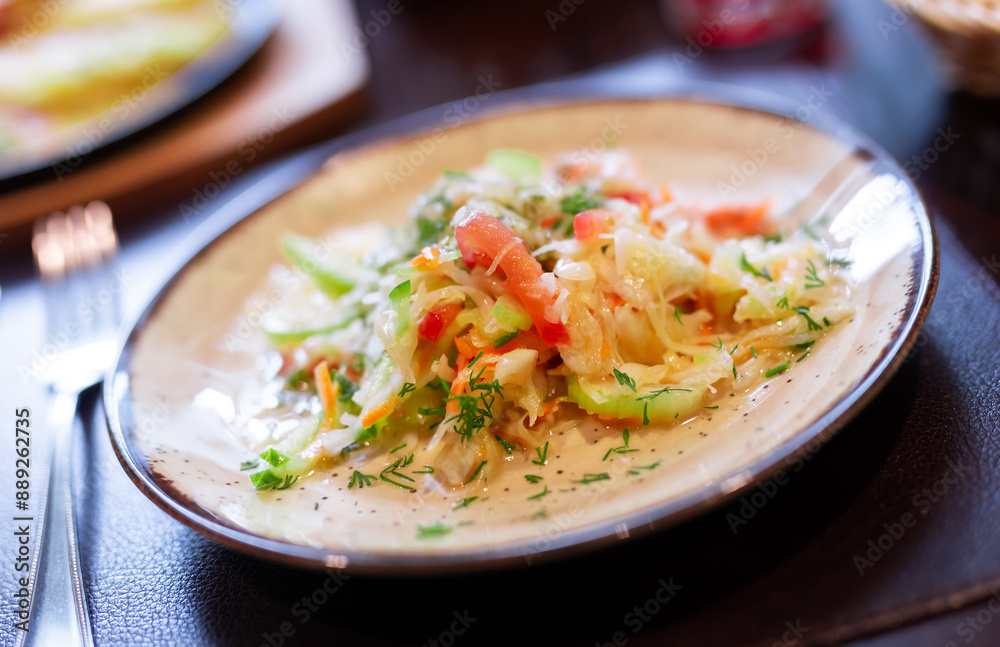 Plate with fresh vegetable salad of tomato, cucumber and celery close up Plate with fresh vegetable salad of tomato, cucumber and celery close up