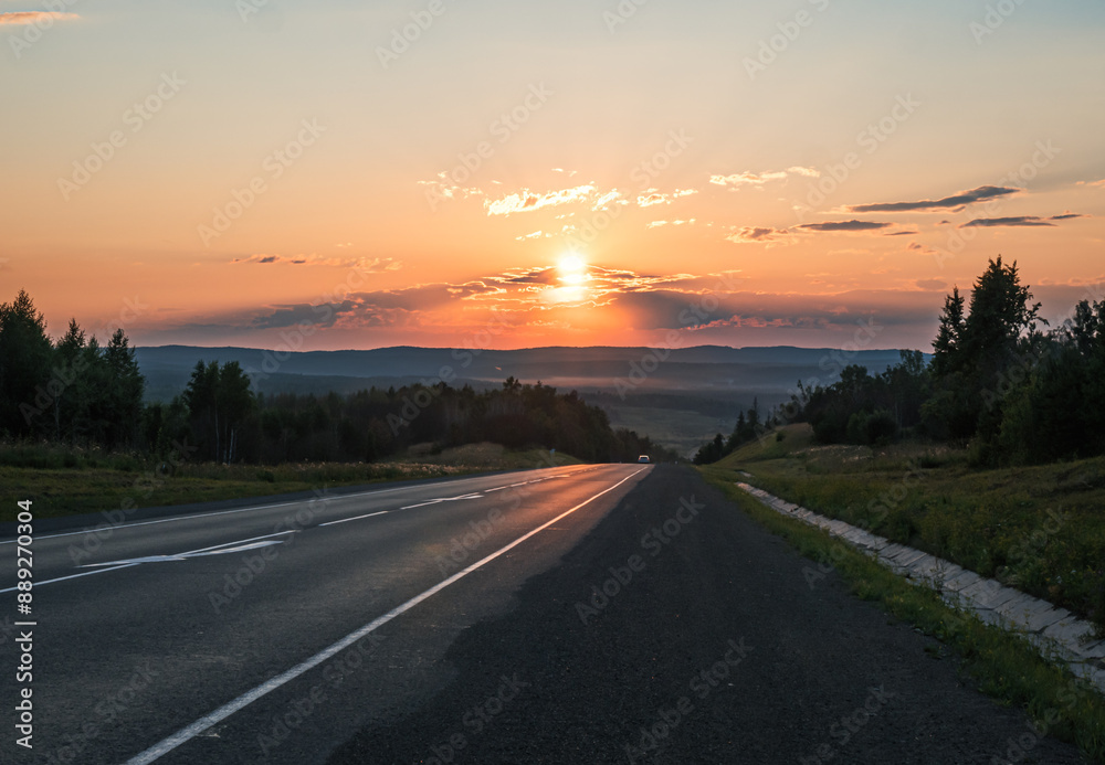 Sun setting over countryside road Sun setting over countryside road
