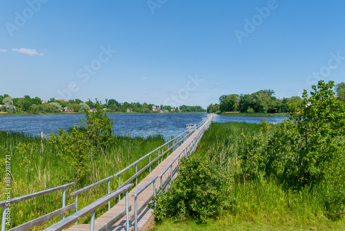 a long wooden footbridge extends far into the lake