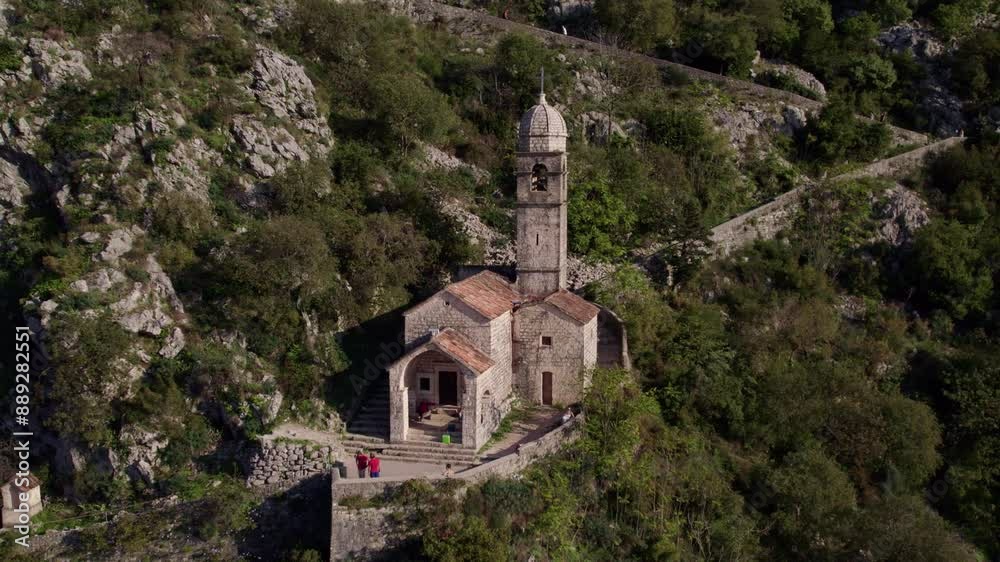 Aerial view of medieval city with church, mountain, forest, and stone pathway, Kotor Bay, Montenegro. Aerial view of medieval city with church, mountain, forest, and stone pathway, Kotor Bay, Montenegro.