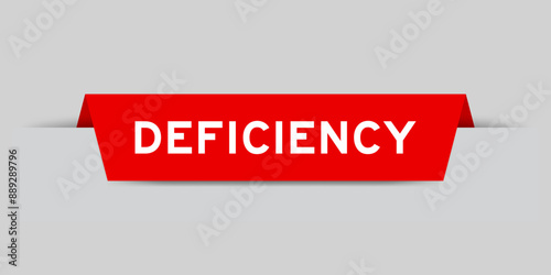 Red color inserted label with word deficiency on gray background