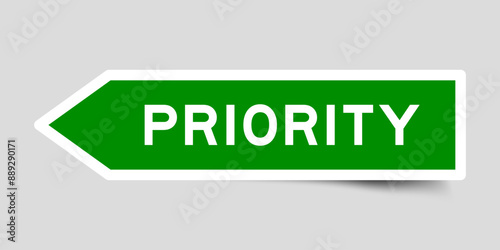 Green color arrow shape sticker label with word priority on gray background