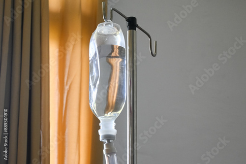 Infusion bottle with IV solution. saline bag hanging on stainless pole. 