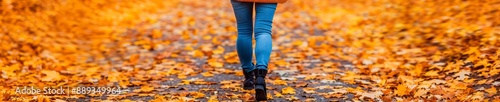 woman walking through autumn leaves - fall foliage, golden colors, warm season, path, footsteps, nature, hiking, outdoor, tranquility, serenity, relaxation. © auc