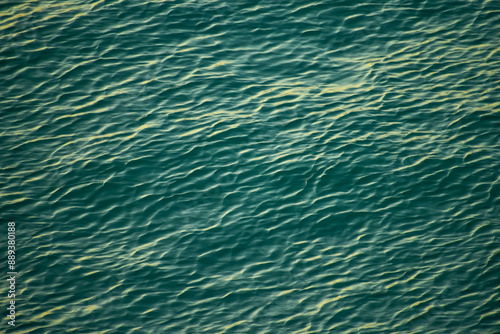 Sea water surface, wave texture. Calm seascape. The background of the blue waters of the sea. Background sea calm water.