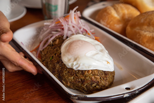 Tacu tacu with fried egg Peruvian breakfast food table with lomo saltado and pejerrey sandwich