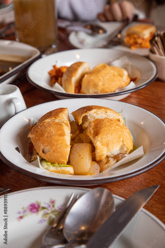 Escabeche sandwich Peruvian breakfast food table with lomo saltado and pejerrey sandwich Escabeche sandwich Peruvian breakfast food table with lomo saltado and pejerrey sandwich