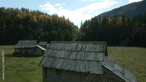 Aerial view of traditional mountain village with forest and mountain, Planina Blato, Slovenia. photo