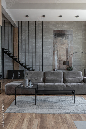 stylish minimalistic restrained modern interior of a two-storey apartment without people in the daytime in loft style in gray tones.