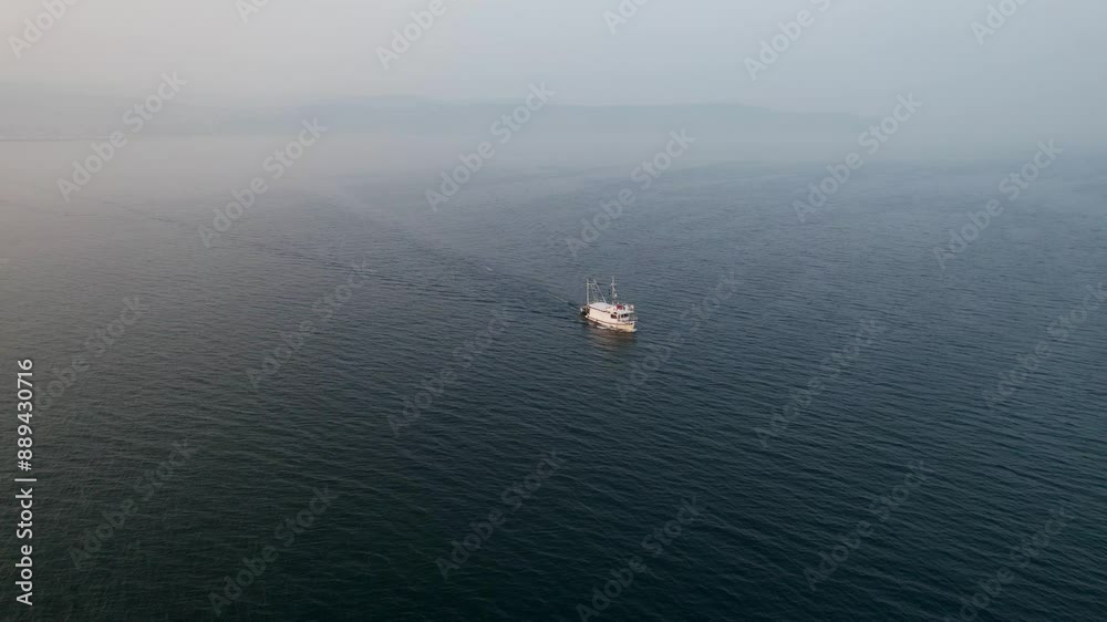 Aerial view of tranquil ocean with fishing boat at sunrise, Izola, Slovenia. Aerial view of tranquil ocean with fishing boat at sunrise, Izola, Slovenia.