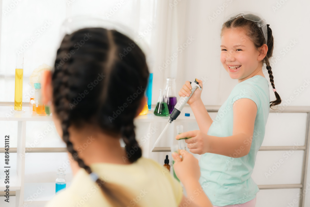 Two young girls engaging in a science experiment with test tubes and beakers, showcasing enthusiasm and curiosity in a bright, educational setting Two young girls engaging in a science experiment with test tubes and beakers, showcasing enthusiasm and curiosity in a bright, educational setting